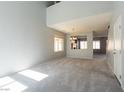 Expansive living room featuring neutral carpet, high ceilings, and natural light from multiple windows at 304 Iron Summit Ave, North Las Vegas, NV 89031