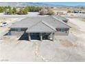 This beautiful home features a covered patio and low maintenance desert landscaping at 3050 Oakridge Ave, Pahrump, NV 89048