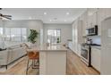 Open concept kitchen featuring a large island with bar seating and modern stainless steel appliances at 3354 Via Strada St, Henderson, NV 89044