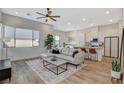 Inviting living room with a neutral color palette, stylish sectional sofa, and modern decor at 3354 Via Strada St, Henderson, NV 89044