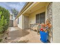 Cozy front porch with tiled flooring, secure gated entry and comfortable outdoor seating arrangement at 3473 Conough Ln, Las Vegas, NV 89129