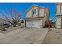 View of a charming two-story home featuring a two-car garage, tile roof, and spacious driveway at 3747 Gulliver St, Las Vegas, NV 89115