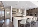 Modern kitchen features an island, stainless steel appliances, and sleek dark cabinetry at 4135 N Durango Dr, Las Vegas, NV 89129