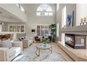 Bright and airy living room with high ceilings, a fireplace, and large windows offering plenty of natural light at 4339 Grey Spencer Dr, Las Vegas, NV 89141