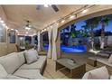 Relaxing covered patio area with comfortable seating overlooking the pool and landscaped backyard at 4339 Grey Spencer Dr, Las Vegas, NV 89141