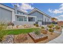 Landscaped yard featuring stone accents, artificial turf, and a walkway leading to the home's front entrance at 4345 N Dapple Gray Rd, Las Vegas, NV 89129