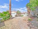 Single story home on a lot featuring desert landscaping with a backdrop of blue sky at 498 Paulson Dr, Las Vegas, NV 89123