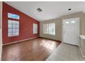 Open concept living room with wood floors, large windows, and natural light at 498 Paulson Dr, Las Vegas, NV 89123