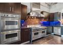 Gourmet kitchen featuring stainless steel Viking appliances, double ovens, and custom cabinetry at 5014 Thunder River Cir, Las Vegas, NV 89148