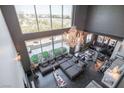 An aerial view of a living room with floor-to-ceiling windows that offer beautiful city views at 5014 Thunder River Cir, Las Vegas, NV 89148