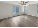 Spacious bedroom featuring hardwood floors, neutral paint, and bright windows with ample natural light at 6228 Grace Mountain St, Las Vegas, NV 89115