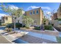 Beautiful two-story home with lush greenery, enhanced curb appeal, and a cozy outdoor seating area at 7609 Trimming Ct, Las Vegas, NV 89149