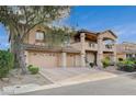 Beautiful two-story home with a tile roof, multiple car garage, and serene landscaping at 8093 Luna Sera Ave, Las Vegas, NV 89178
