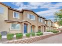 Exterior shot of townhomes showcasing appealing design and well-maintained landscaping at 8520 Insignia Ave # 104, Las Vegas, NV 89178