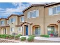 Attractive townhome showcasing covered entryways and neutral tones at 8520 Insignia Ave # 104, Las Vegas, NV 89178