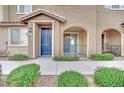 Inviting townhome exterior featuring a blue front door and private entry at 8520 Insignia Ave # 104, Las Vegas, NV 89178