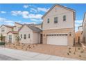 Charming two-story home featuring neutral siding, stone accents, a two-car garage, and a well-maintained front yard at 8979 Rolling Pietra St, Las Vegas, NV 89166