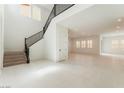 Bright foyer with staircase and tile flooring that leads into the open-concept living area, perfect for entertaining at 8979 Rolling Pietra St, Las Vegas, NV 89166
