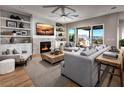 Inviting living room with fireplace, custom built-ins, and sliding glass doors to an outdoor space at 8979 Rolling Pietra St, Las Vegas, NV 89166