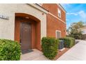 Inviting front entrance with a classic brown door and manicured landscaping at 9303 Gilcrease Ave # 1013, Las Vegas, NV 89149