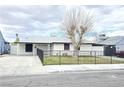 Charming single-story home featuring a fenced front yard with low maintenance landscaping and a gray exterior at 1021 Wengert Ave, Las Vegas, NV 89104