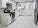 Bright kitchen features stainless steel appliances, modern countertops, and white cabinets for a clean aesthetic at 1021 Wengert Ave, Las Vegas, NV 89104