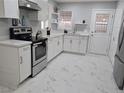 Bright kitchen features stainless steel appliances, modern countertops, and white cabinets for a clean aesthetic at 1021 Wengert Ave, Las Vegas, NV 89104
