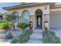 Inviting front entrance with stone accents, desert landscaping and a tiled walkway leading to the front door at 12121 Cabo Rojo Ave, Las Vegas, NV 89138