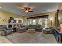 Spacious living room with a plush carpet, comfortable seating, and seamless access to the outdoor area at 12121 Cabo Rojo Ave, Las Vegas, NV 89138