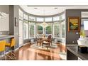 Bright dining area with a chandelier and curved wall of windows offering pleasant views at 1732 Cypress Manor Dr, Henderson, NV 89012