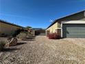 Exterior view of a home with desert landscaping, gravel, and a brick paver driveway at 2040 Port Royal Dr, Laughlin, NV 89029