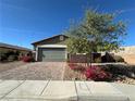 Attractive single-story house showcasing a well-maintained lawn and desert landscaping under a clear blue sky at 2040 Port Royal Dr, Laughlin, NV 89029