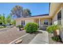 Inviting front entrance with a covered porch, desert landscaping, and a well-maintained walkway at 2240 Grayson Cir, Henderson, NV 89014