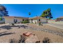 Beautifully landscaped front yard with desert landscaping, rocks, and a charming single story home at 2240 Grayson Cir, Henderson, NV 89014
