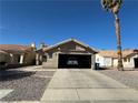 Single-story home featuring a red tile roof, stucco exterior, and attached garage at 2266 Carved Canyon Ln, Laughlin, NV 89029