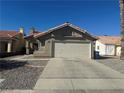 Exterior of the house featuring well-maintained landscaping, stucco and red tiled roof at 2266 Carved Canyon Ln, Laughlin, NV 89029
