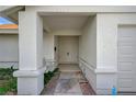 Covered front porch with swing, leading to a double door entry and attached two-car garage at 2367 E Hacienda Ave, Las Vegas, NV 89119