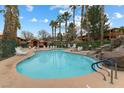 Community pool area offers a refreshing escape, surrounded by palm trees and lounge chairs at 313 Haley Way # D, Mesquite, NV 89027