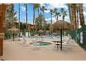 Community pool featuring a jacuzzi, lounging area, and plenty of shade at 313 Haley Way # D, Mesquite, NV 89027