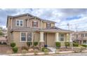 Attractive two-story home featuring a covered porch with stone accents and manicured landscaping at 3237 Mist Effect Ave, Henderson, NV 89044