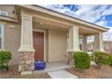 Inviting covered porch with stately columns and stone accents, perfect for relaxing outdoors at 3237 Mist Effect Ave, Henderson, NV 89044
