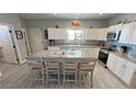 Beautiful kitchen with white cabinetry, granite countertops, stainless steel appliances, and large island with seating at 3341 S Big Sky Way, Pahrump, NV 89048