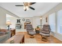 Open-concept living room with wood floors, neutral walls, and modern furnishings at 3753 Heritage Ave, Las Vegas, NV 89121