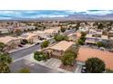 This aerial view captures the neighborhood homes with their terracotta roofs and solar panels, complemented by mountain views at 4401 Lilac Glen Dr, Las Vegas, NV 89129