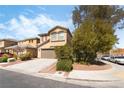 This lovely home features mature trees, a 2-car garage, and a welcoming facade at 4650 Chino Peak Ct, Las Vegas, NV 89139