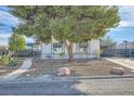 Single-story home featuring mature trees, low-maintenance landscaping, and a covered parking area at 518 Topaz Ave, Henderson, NV 89015