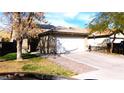 Street view of a well-maintained one-story home featuring a two-car garage and desert landscaping at 5856 Sutcliffe Cir, Las Vegas, NV 89110