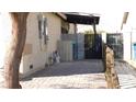 Paver patio and gated side yard featuring desert landscaping at 5856 Sutcliffe Cir, Las Vegas, NV 89110
