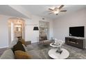 Living room with neutral color scheme, ceiling fan, modern furniture, and an archway to the bathroom at 6160 Rumrill St # 201, Las Vegas, NV 89113