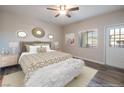 Main bedroom with a ceiling fan, exterior door, neutral color palette, and bright natural light at 6160 Rumrill St # 201, Las Vegas, NV 89113